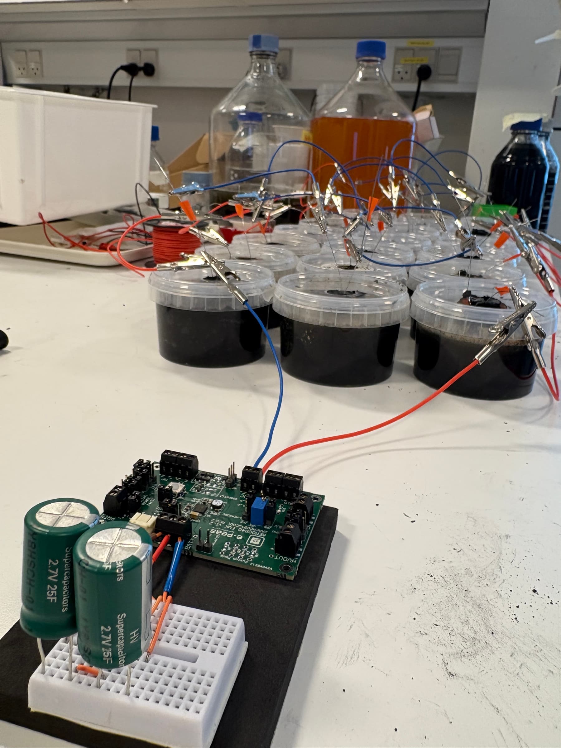 Energy harvesting board connected to microbial fuel cells and supercapacitors